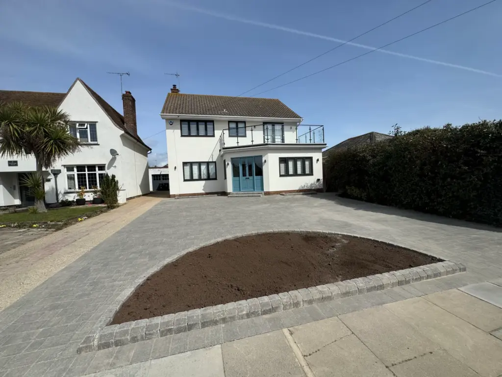 Completed block paved driveway in Frinton-on-Sea with a circular planting bed and parking for up to five cars