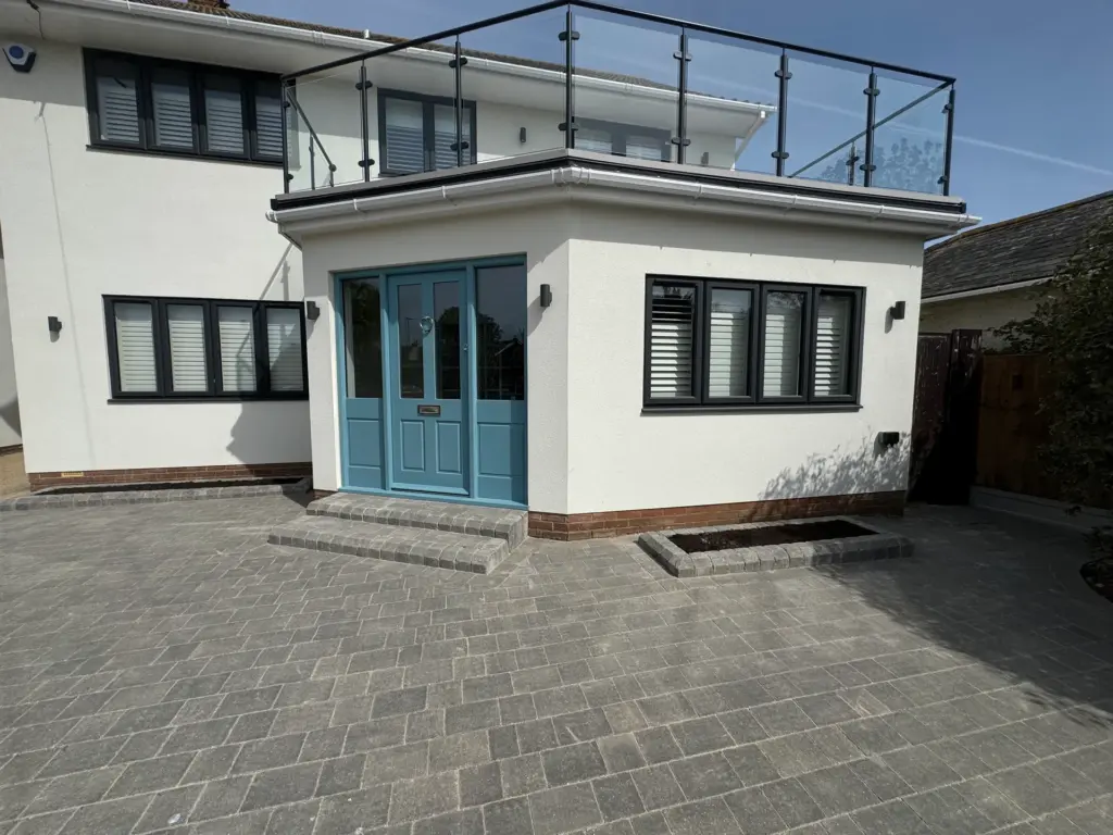 Block paved driveway beneath the renovated bay-fronted extension and glass balcony of a Frinton-on-Sea home