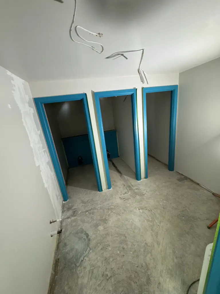 New teal door linings fitted during the washroom reconfiguration at The Hawthorns School in Chelmsford