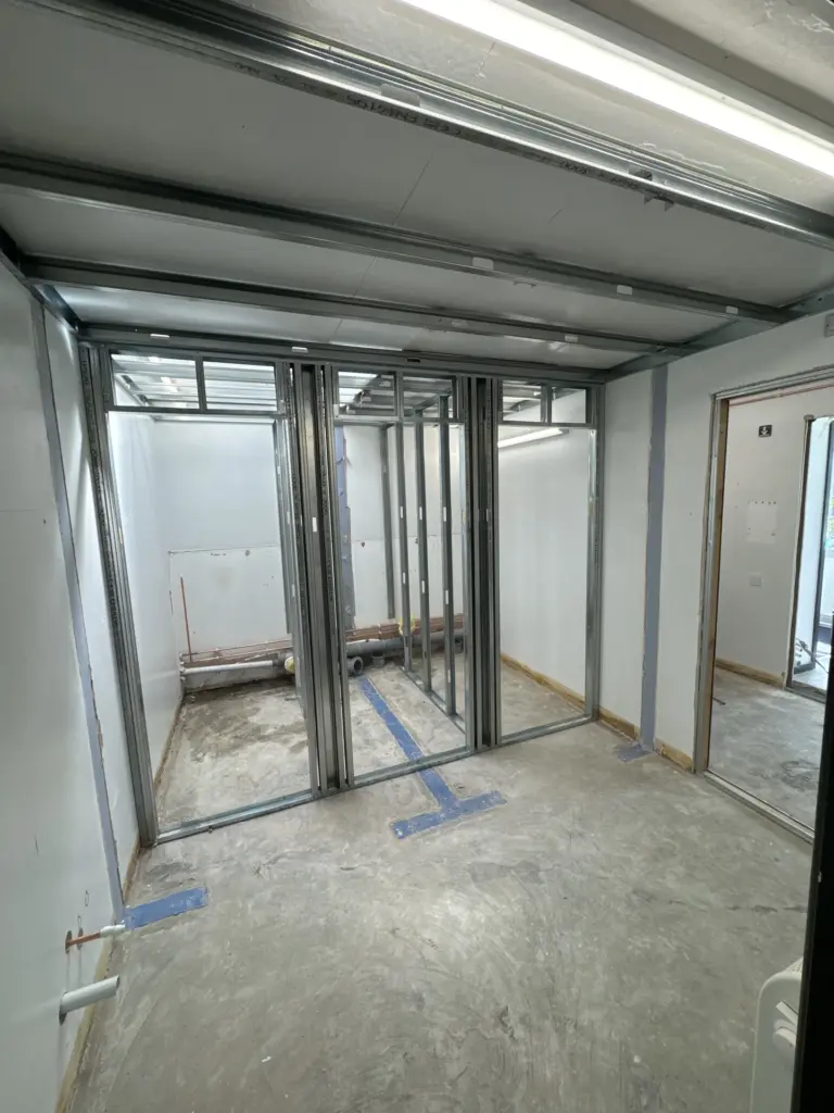 Cubicle partition framing beneath a roof light at The Hawthorns School washroom in Chelmsford
