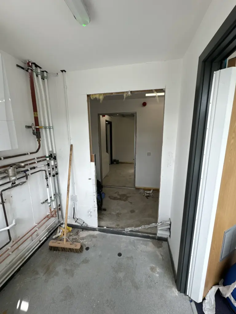 First-fix plumbing manifold and pipework during The Hawthorns School washroom refurbishment in Chelmsford