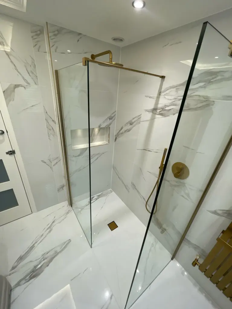 Walk-in shower with frameless glass screen and brushed brass fittings Hutton bathroom