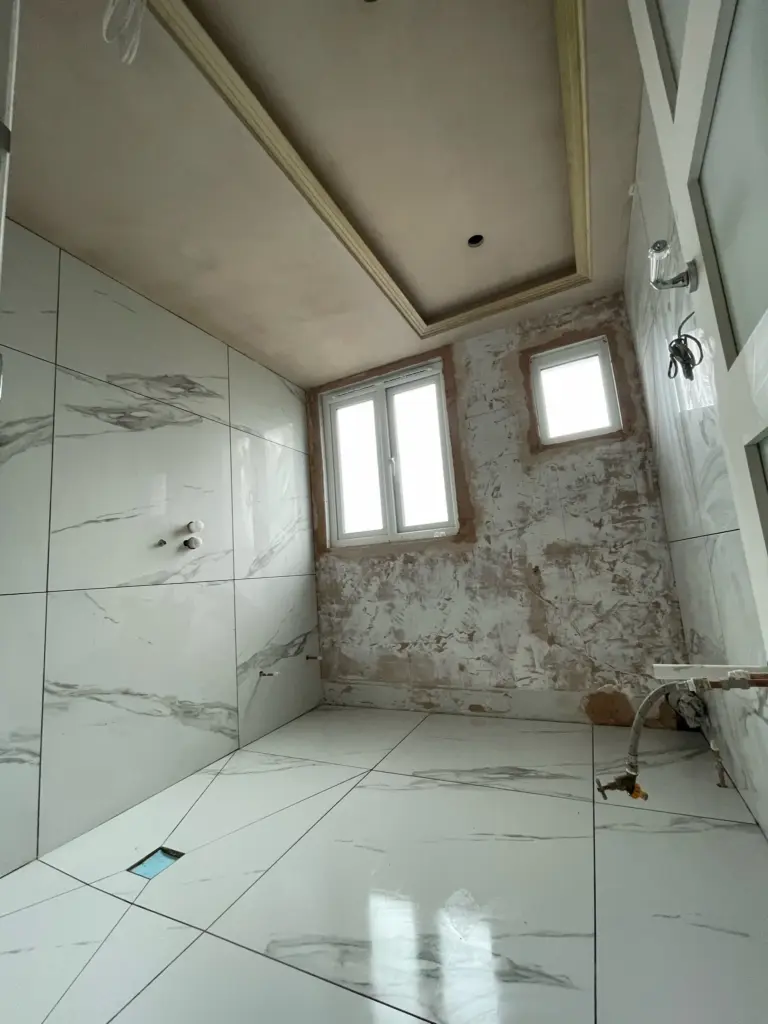 Large format porcelain tile installation in progress