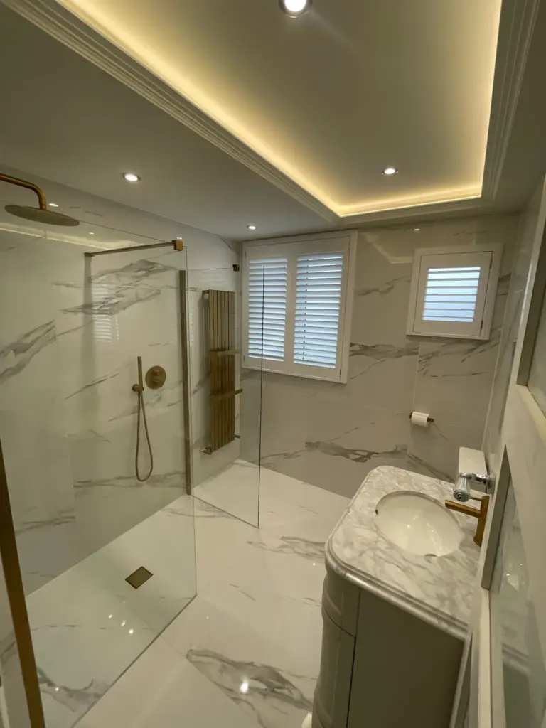 Completed bathroom installation in Hutton, Essex with recessed ceiling lighting and large format porcelain tiles