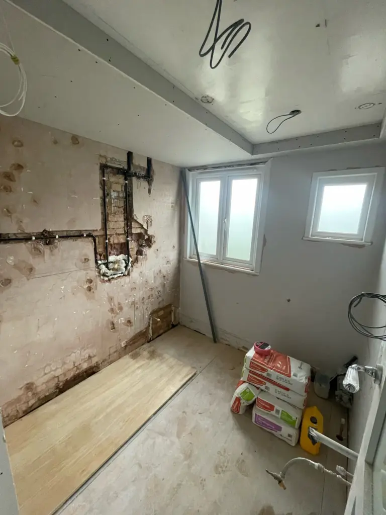 Bathroom renovation in progress showing new plumbing layout