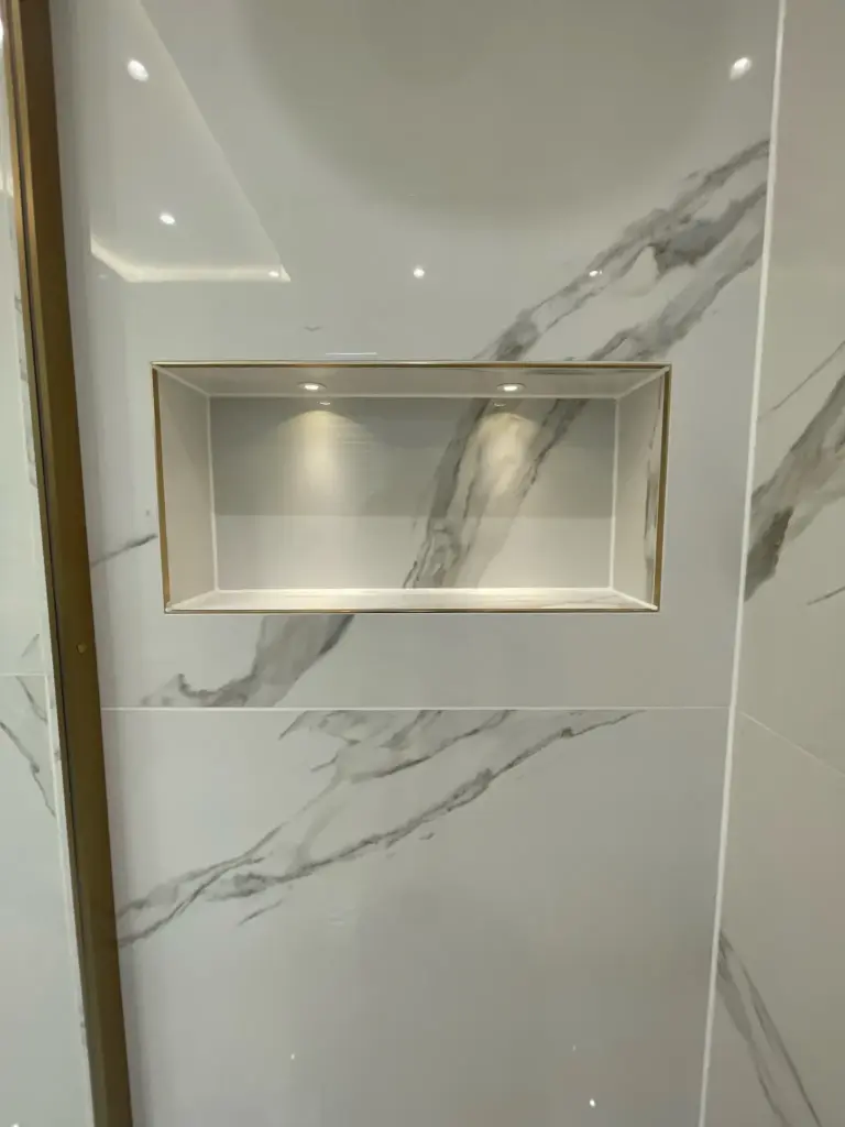 Recessed shower niche with large format porcelain tiling