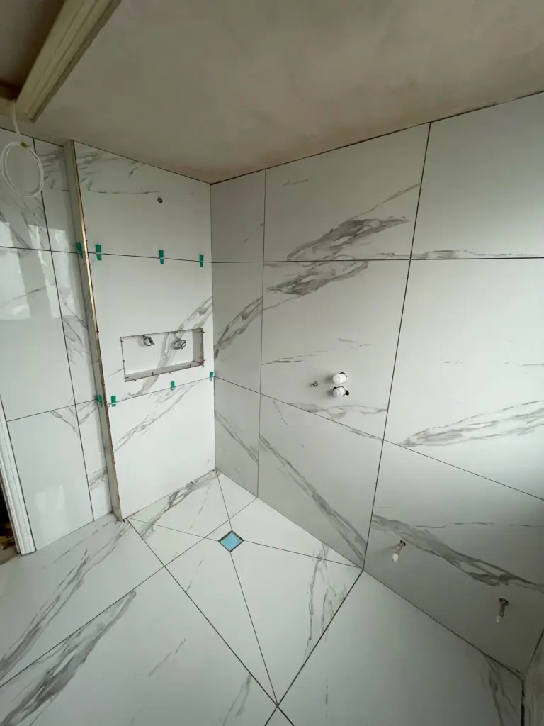 Large format porcelain tile installation in progress