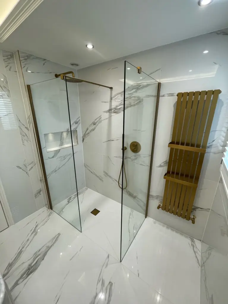 Walk-in shower with frameless glass screen and brushed brass fittings Hutton bathroom