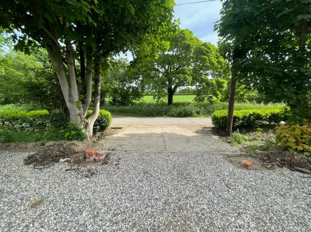 Existing front boundary and driveway approach before work in Rivenhall