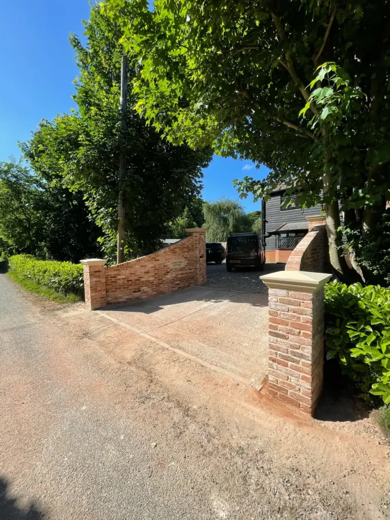 Brick driveway piers under construction at the Rivenhall entrance