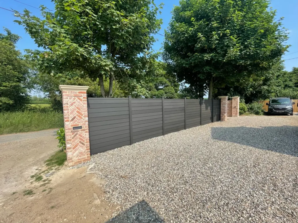 Completed Rivenhall driveway with composite front boundary fencing and brick piers