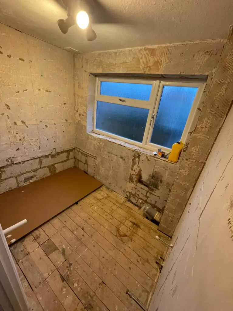 Bathroom stripped back to the floor and wall structure during refurbishment in Tiptree