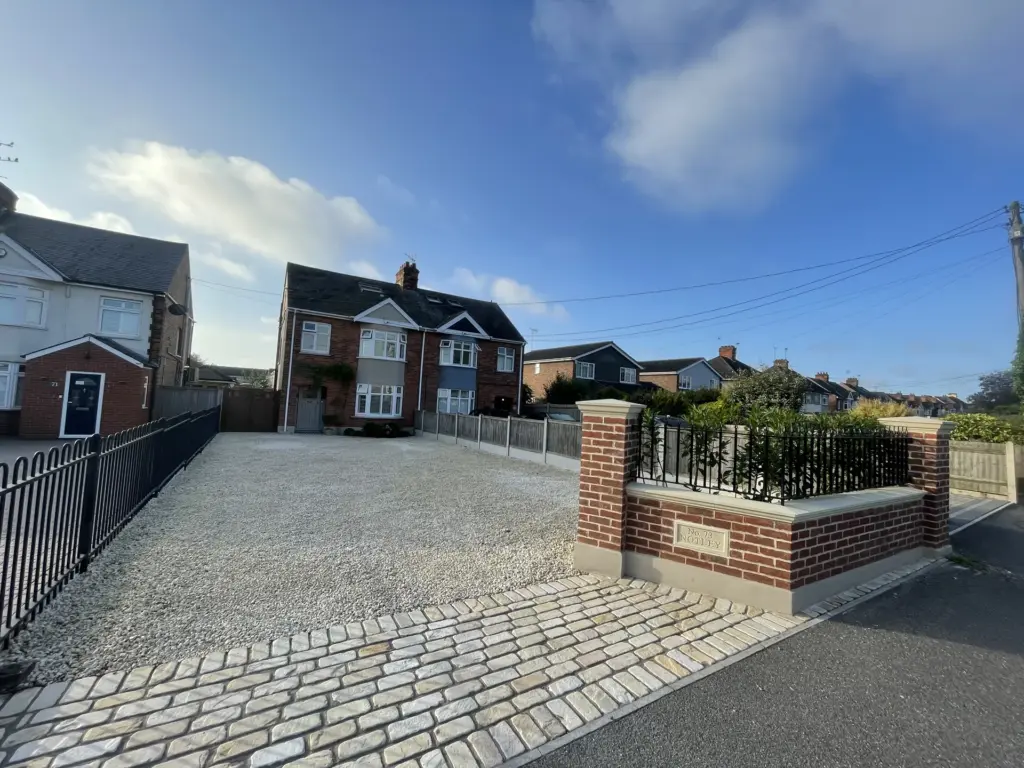 Wide view of the completed Witham driveway entrance and cobble apron