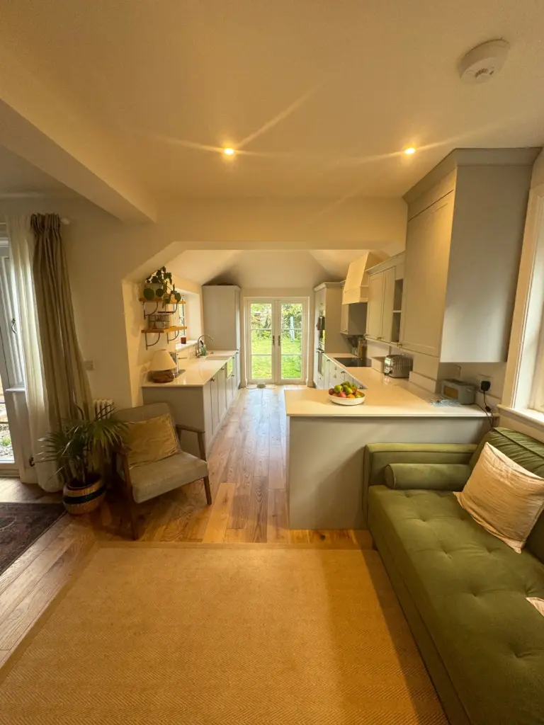 Finished open-plan kitchen and dining area in this Witham home, with engineered wood flooring and garden views