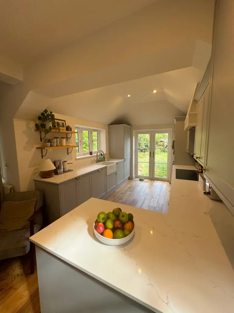 Finished Witham kitchen looking toward the new rear French doors and garden, with bespoke cabinetry either side