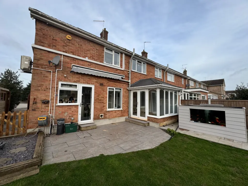 Rear of a Writtle property before the single storey extension, with the original hip-roofed conservatory and garden