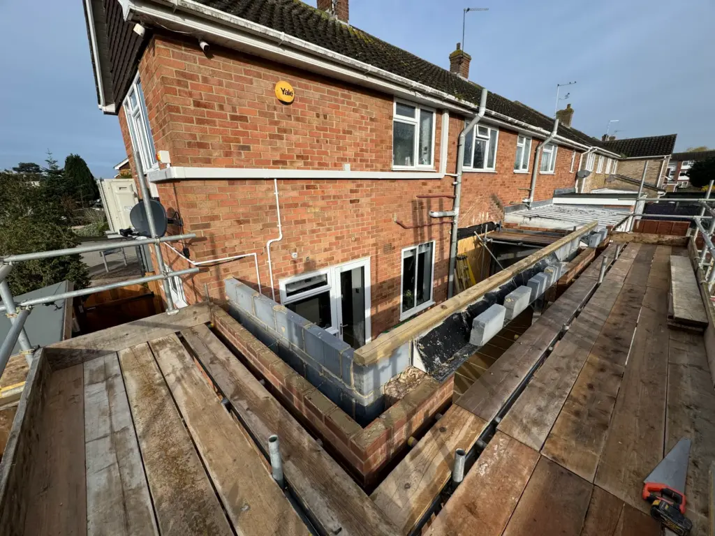 Blockwork upstand wall being built at wall-plate height during the Writtle rear extension build