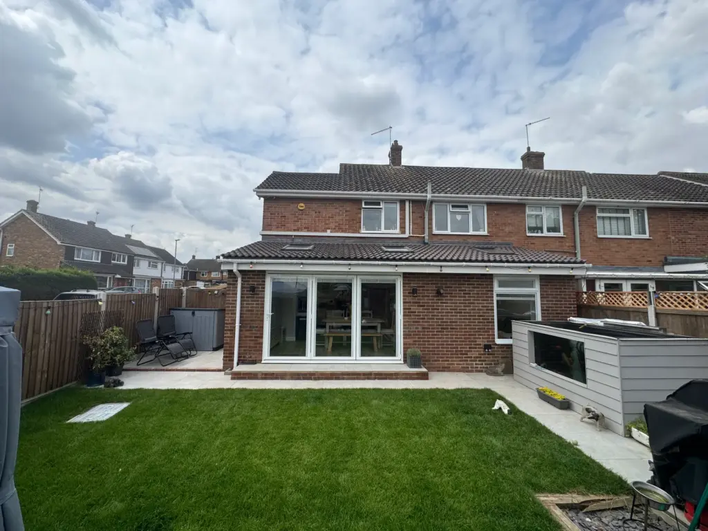 Rear elevation of the completed single storey rear extension in Writtle with the garden turfed and the patio finished
