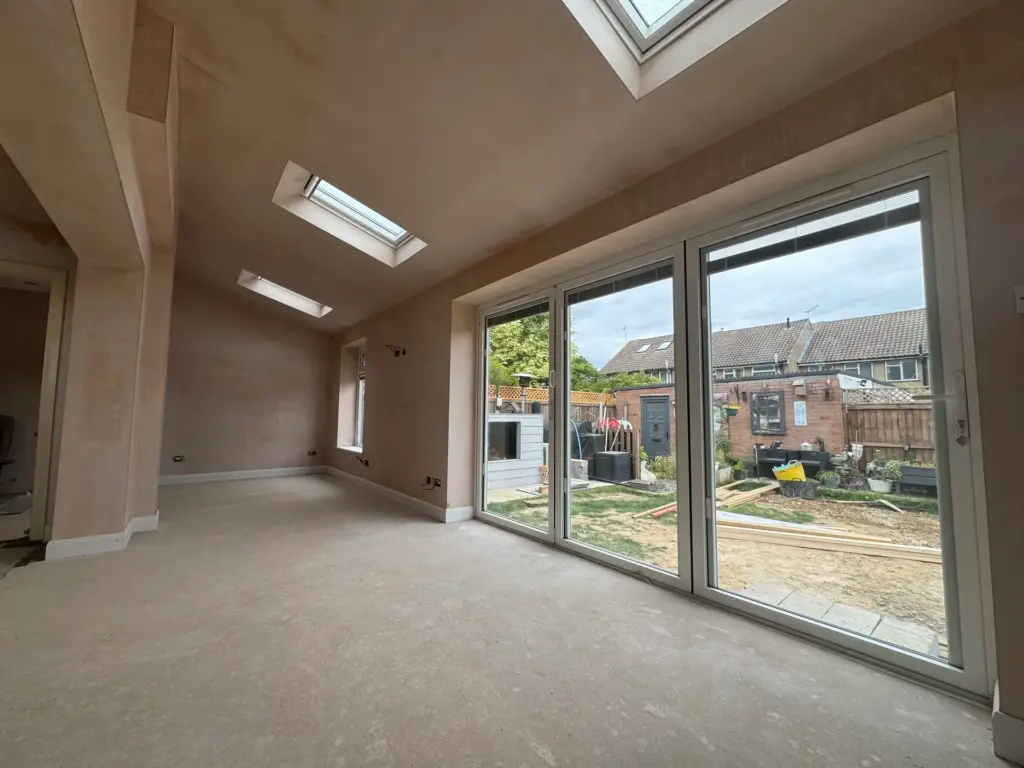 Finished living and dining space in the Writtle extension with full-width bi-fold doors open to the garden