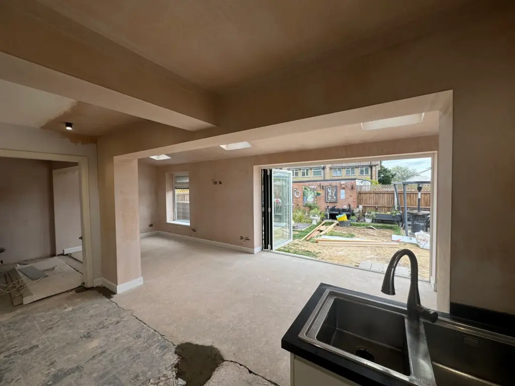 Freshly plastered open-plan extension in Writtle with roof windows and bi-fold doors to the garden