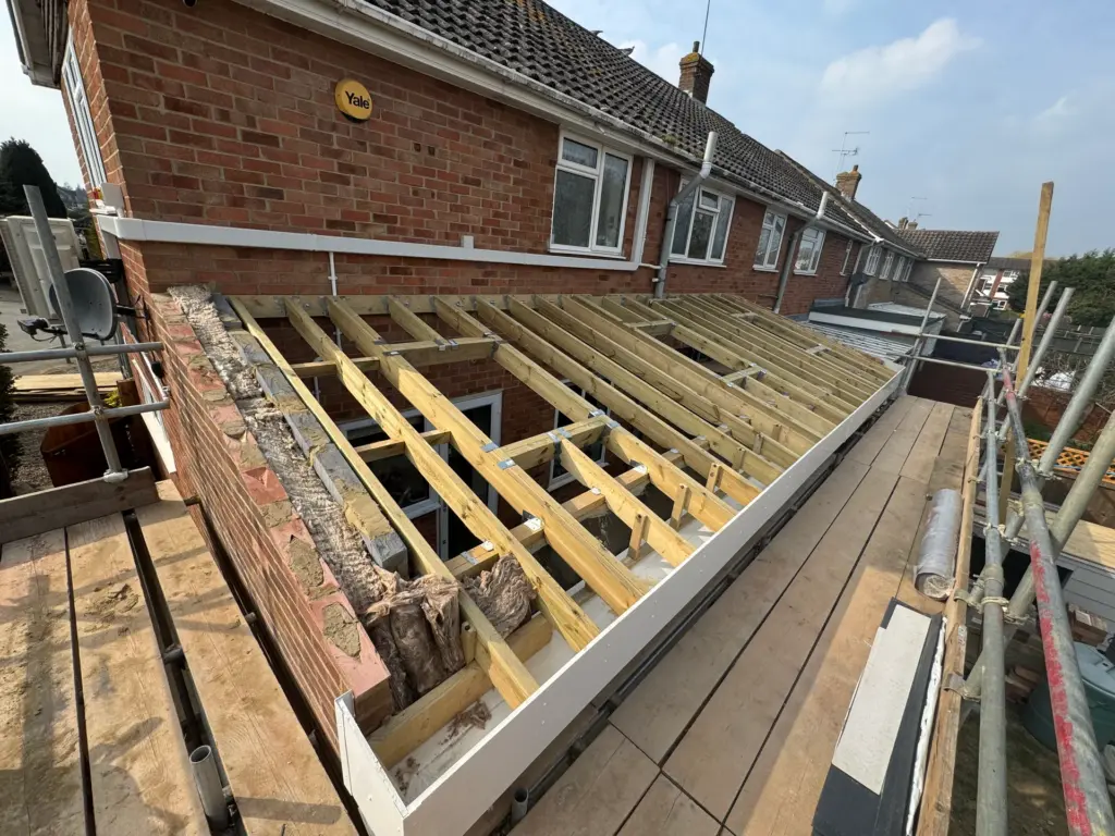 Timber roof joists and insulation installed for the lean-to roof of the Writtle extension