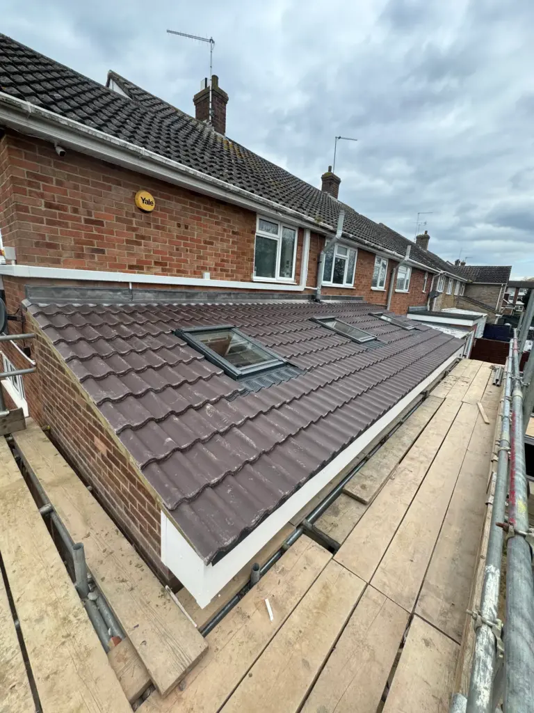 Completed tiled lean-to roof matching the existing house tiles, with roof window, on the Writtle extension