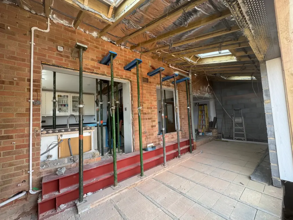 Steel beam supported on acrow props during the structural knock-through for the Writtle kitchen extension