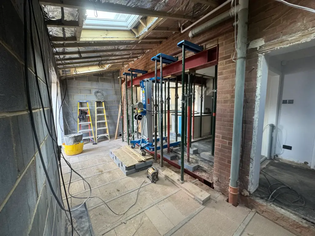 Steel beam and acrow props viewed through to the original kitchen during the Writtle extension build